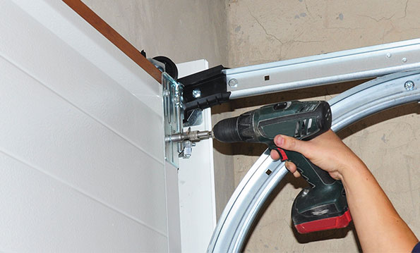 door technician performing a residential garage door repair