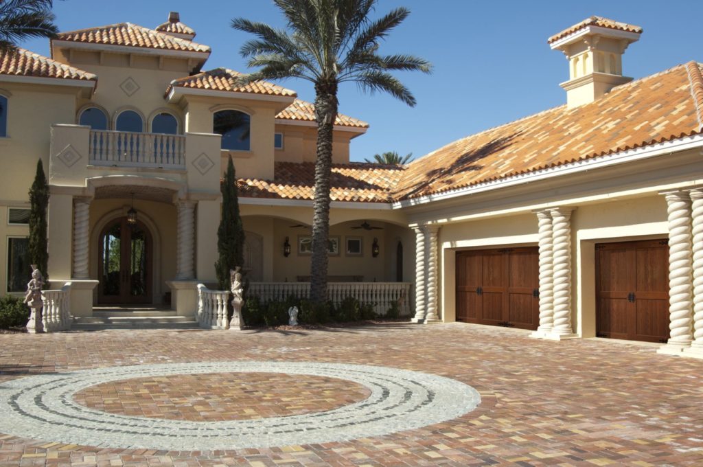 Clopay Canyon Ridge Limited Edition Garage Door on a Spanish-Style house with Palm Trees